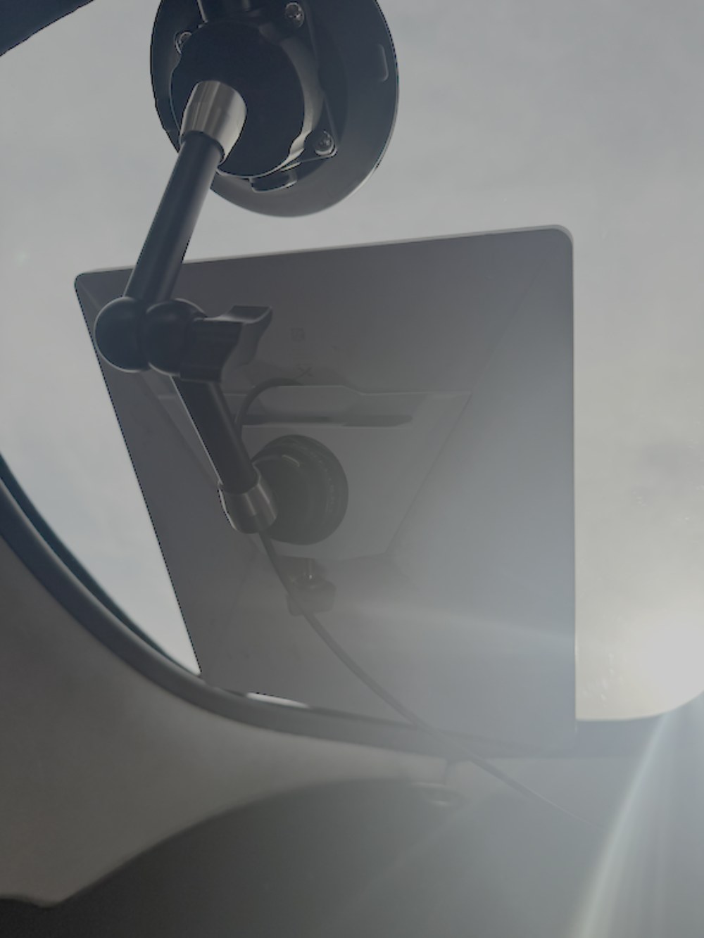Starlink Aviation dish on a portable suction-cup mount inside the cabin